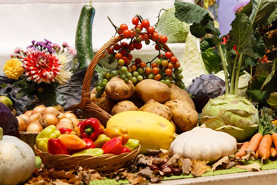 Arrangement aus frischem Gemüse und Blumen zu Erntedank.