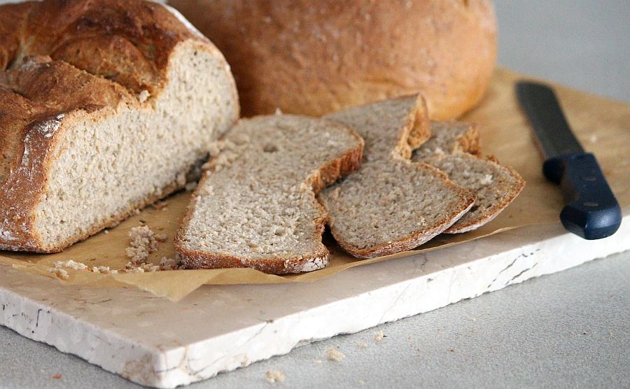 angeschnittenes Brot auf Brett mit Messer