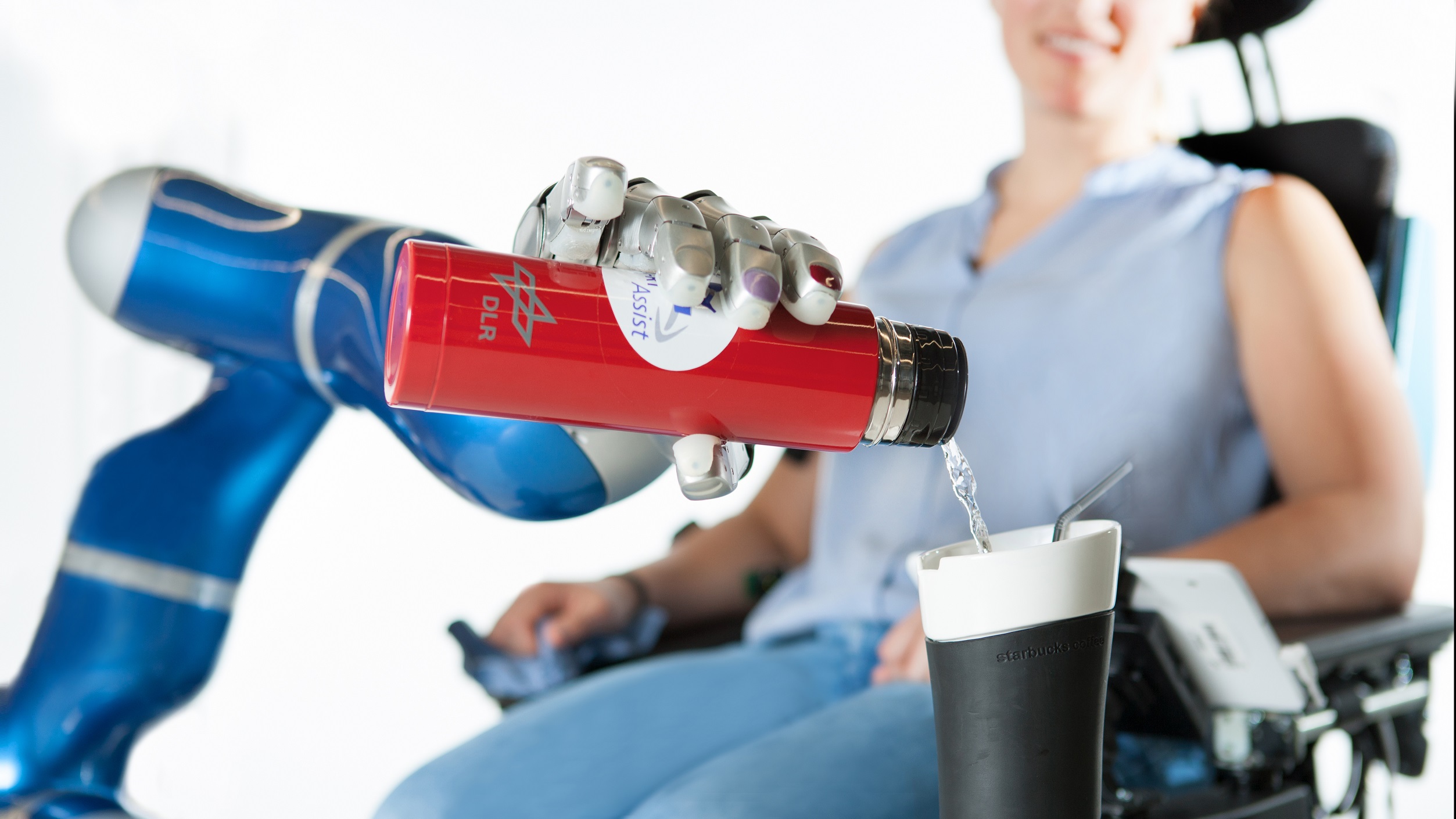 Der intelligente Greifarm EDAN kann mittels Muskelsignale Wasser in ein Glas einschenken.