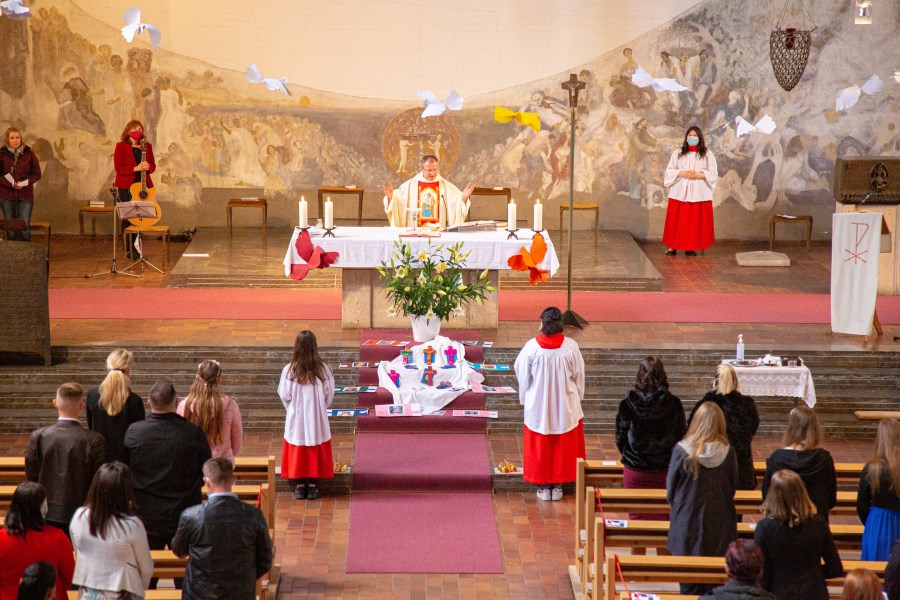 Mnistrantinnen stehen vor dem Altar.