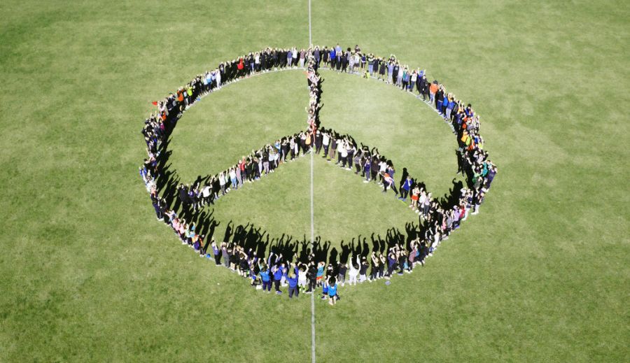 Schülerinnen und Schüler der Maria-Ward-Realschule St. Zeno in Bad Reichenhall formen ein Friedenssymbol