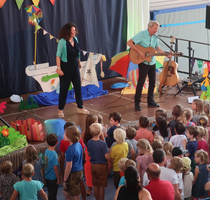 Die Kinder stehen vor der Bühne und singen mit Margit und Werner von "Sternschnuppe" die Sommerlieder.