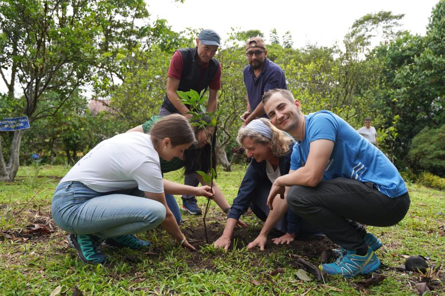 Mitglieder der Delegation und ehemalige Freiwillige pflanzen im Laudato si-Park Mandarinen- und Orangenbäume