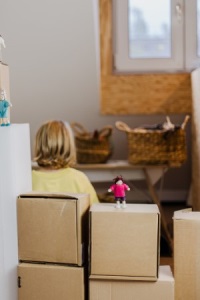 Kind sucht Schutz in der Burg aus Kartons