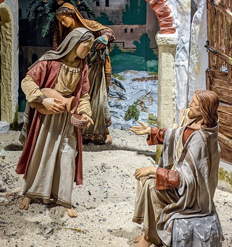 Frau reicht Jesus Wasser am Jakobsbrunnen