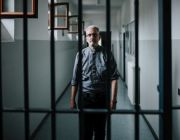 Gefängnisseelsorger Oskar Ehehalt auf einem Gang hinter Gittern in der Justizvollzugsanstalt Garmisch-Partenkirchen