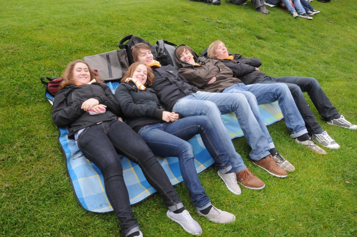 Jugendliche liegen auf einer modernen Gemeinschaftsholzliege